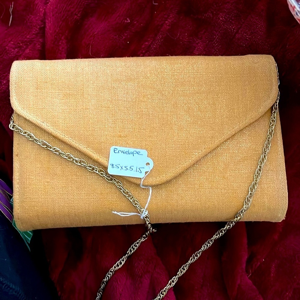 Golden envelope shaped shoulder bag with chain strap. No call outs 8.5x8.5x1.5